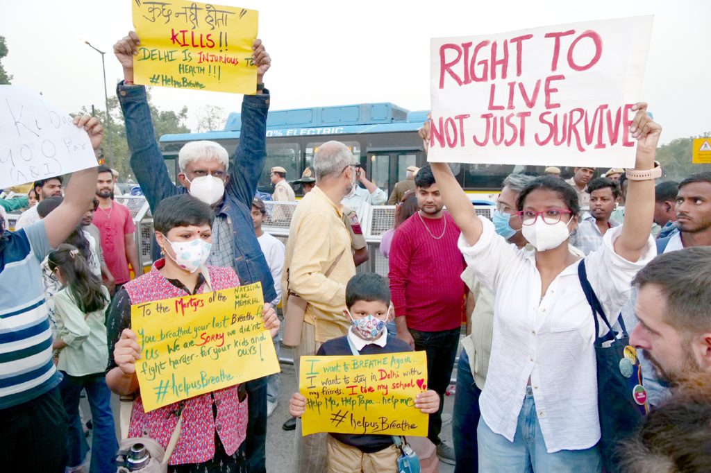 People stage a protest over rising pollution levels at India Gate