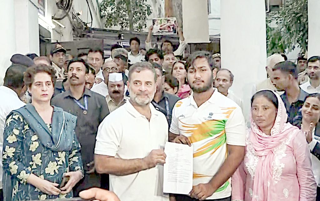 Lok Sabha LoP Rahul Gandhi and Sahil Lochav show the FIR copy after Delhi Police registered an FIR on Lochav's complaint